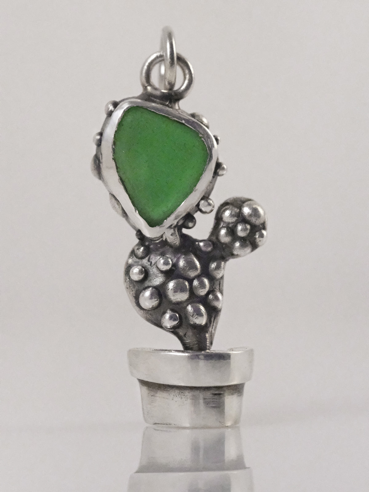 Silver cactus pendant with green sea glass fragment handmade by VerdeRame Jewels
