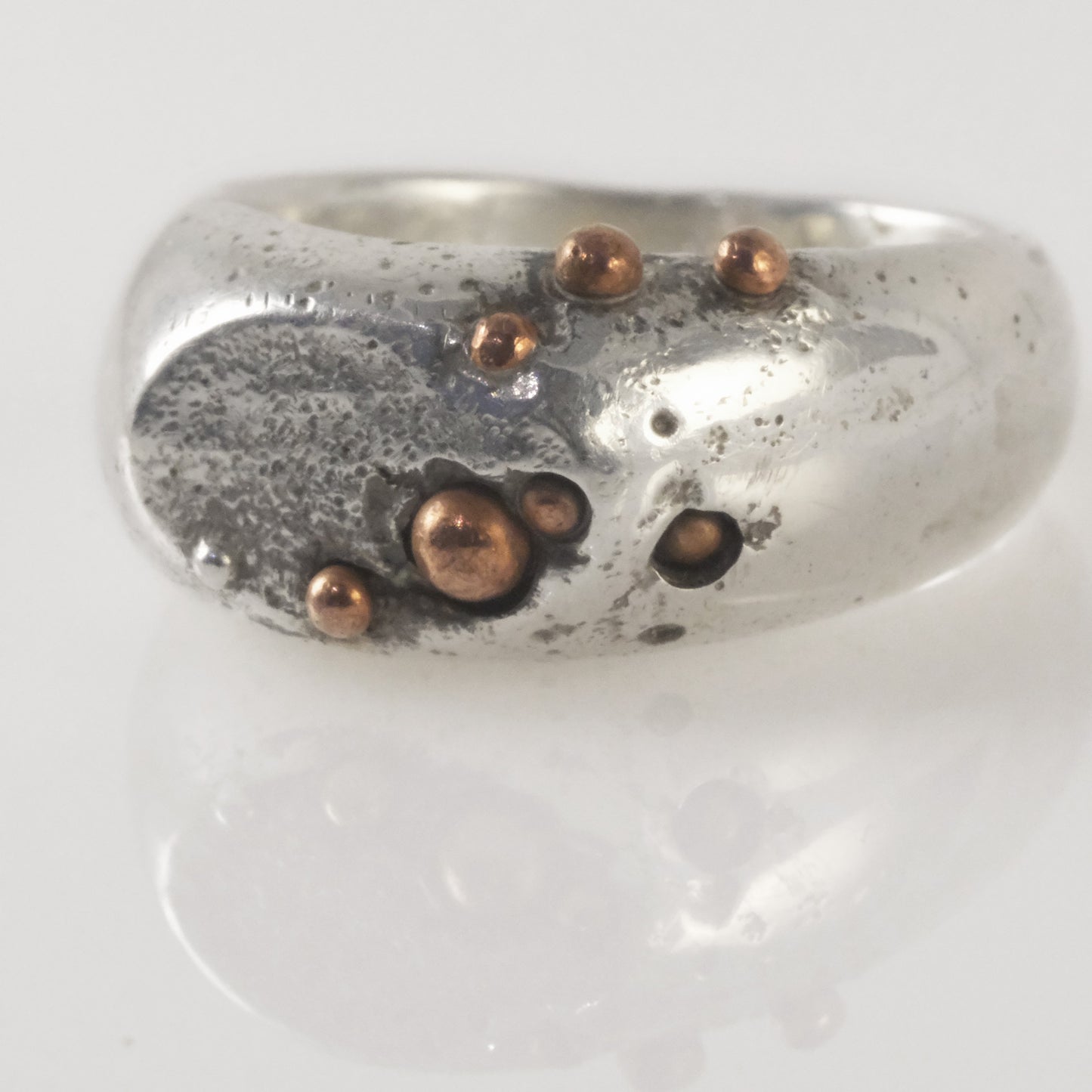 Sand-cast signet ring with copper granules handmade by VerdeRame Jewels