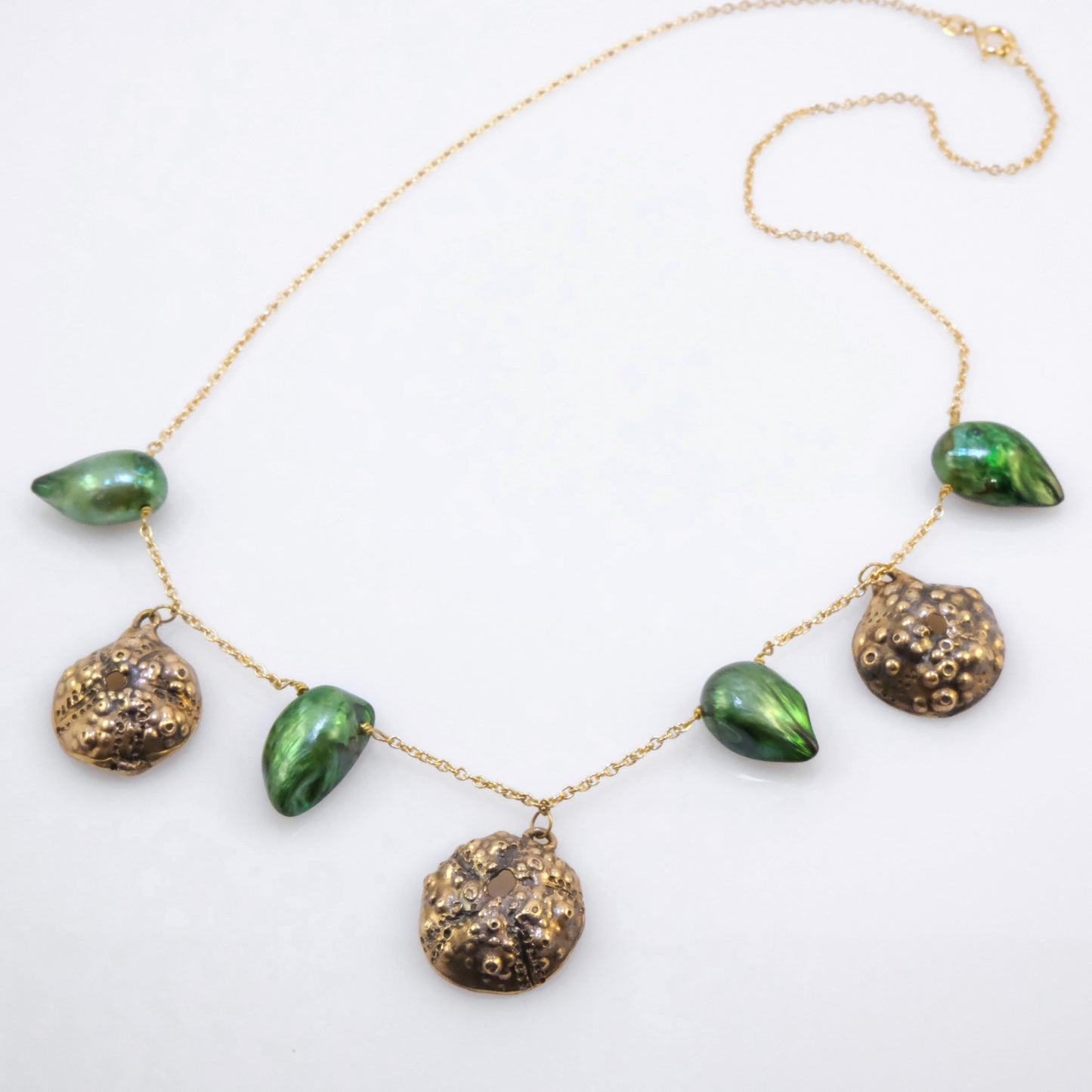 Bronze urchin necklace with green pearls handmade by VerdeRame Jewels