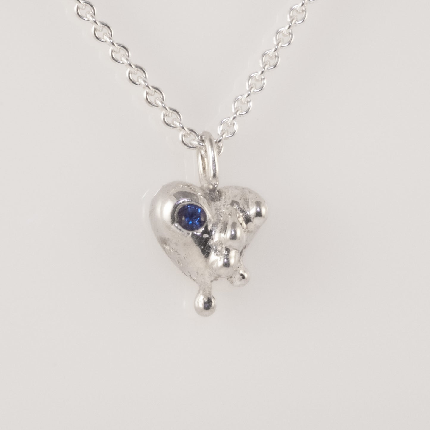 Heart pendant showing texture and blue zirconia detail, handmade by VerdeRame Jewels