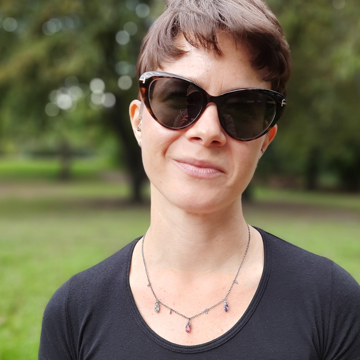 Handmade sterling silver marquise crystal necklace with small silver ball charms worn by model