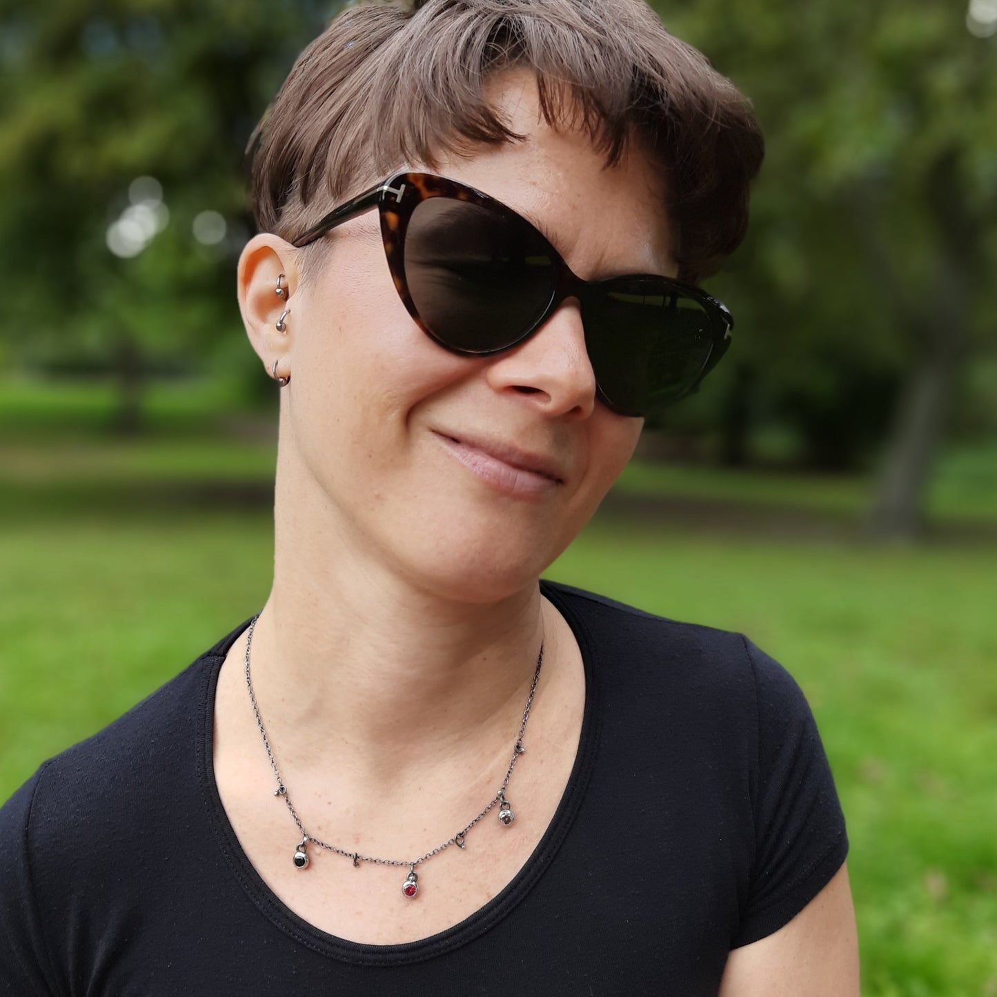 Quirky delicate necklace with playful silver ball and zirconia charms