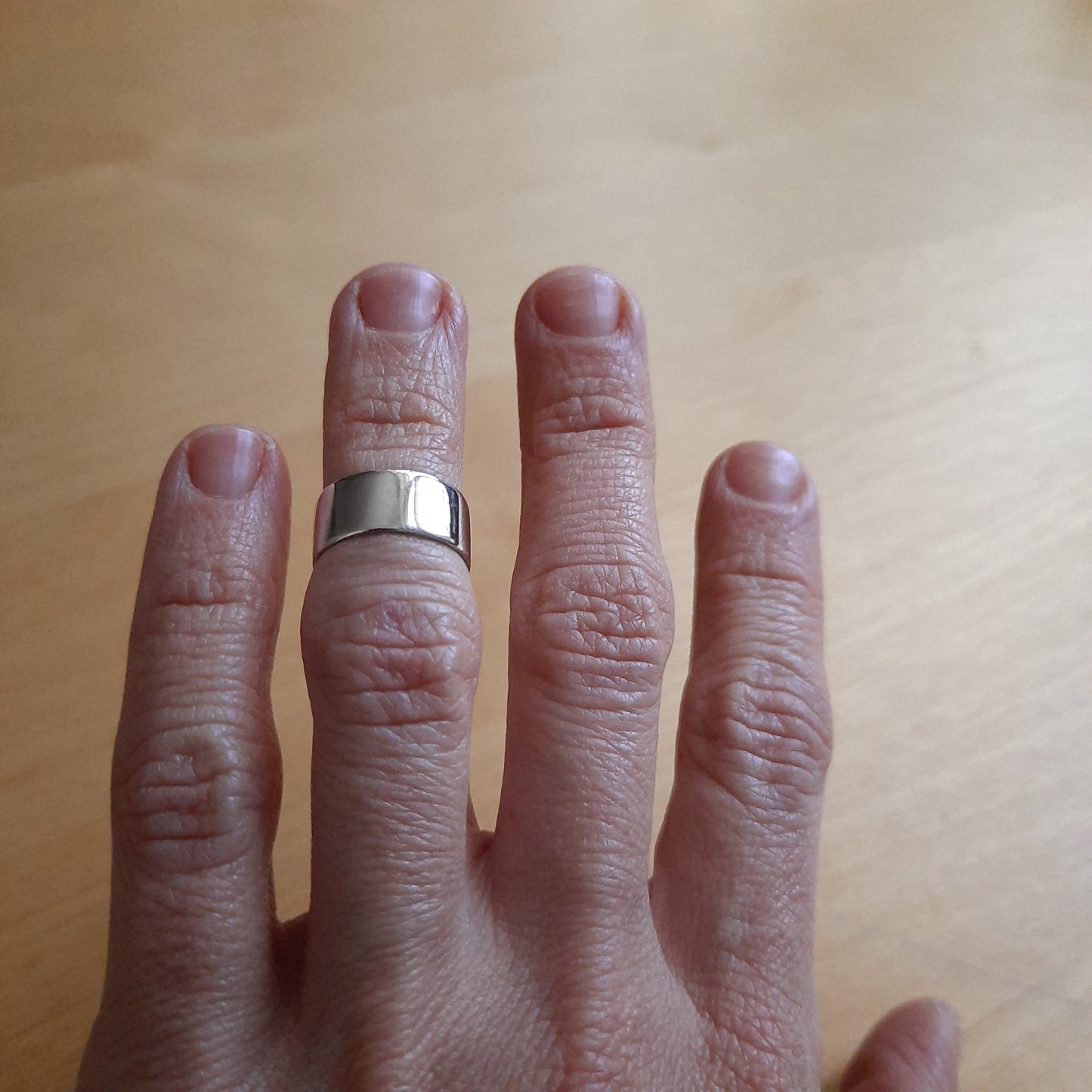 Versatile unisex sterling silver band ring design.