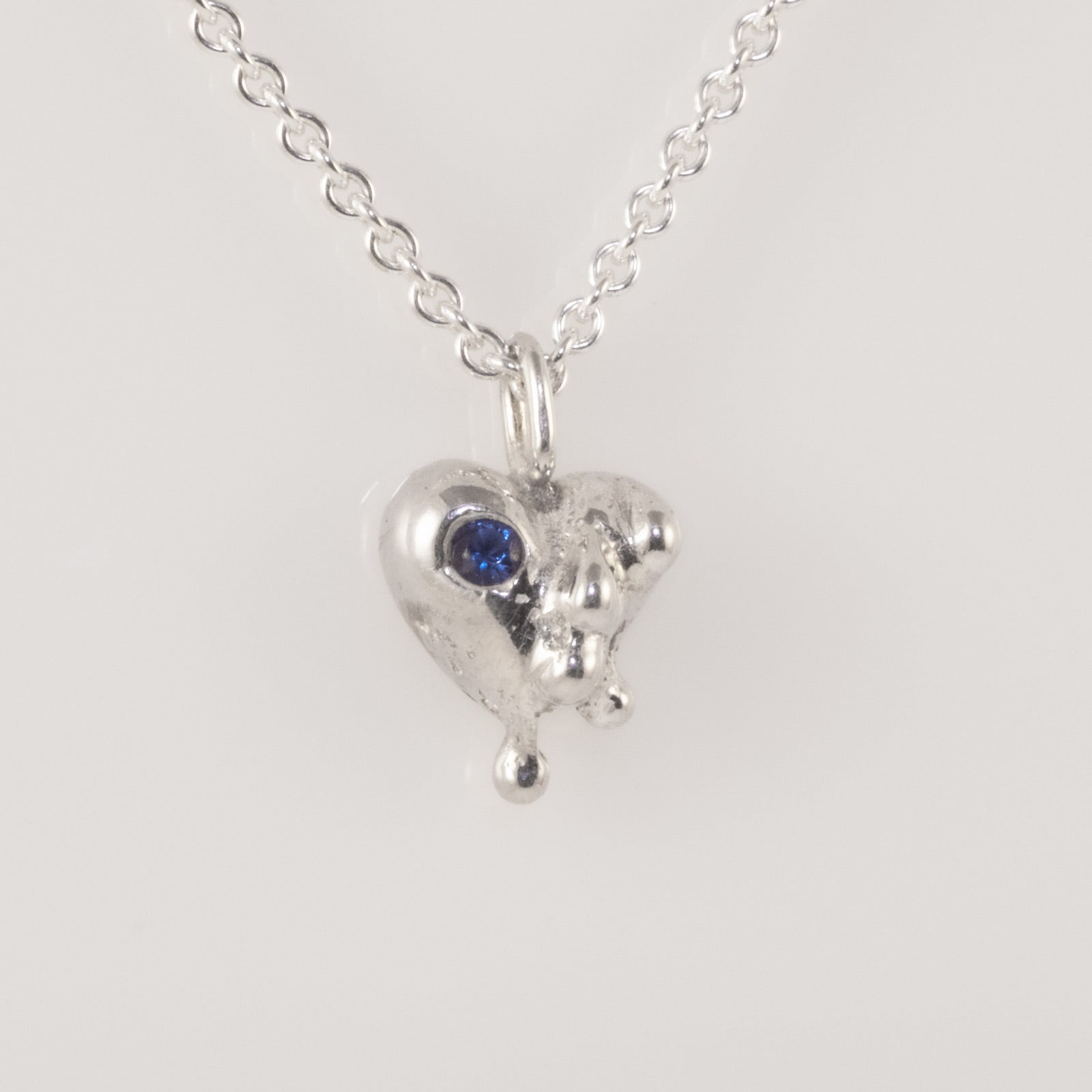 Heart pendant showing texture and blue zirconia detail, handmade by VerdeRame Jewels