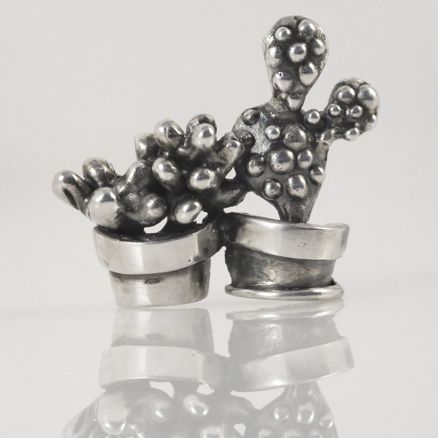 Detail of double cactus pendant, oxidised and polished