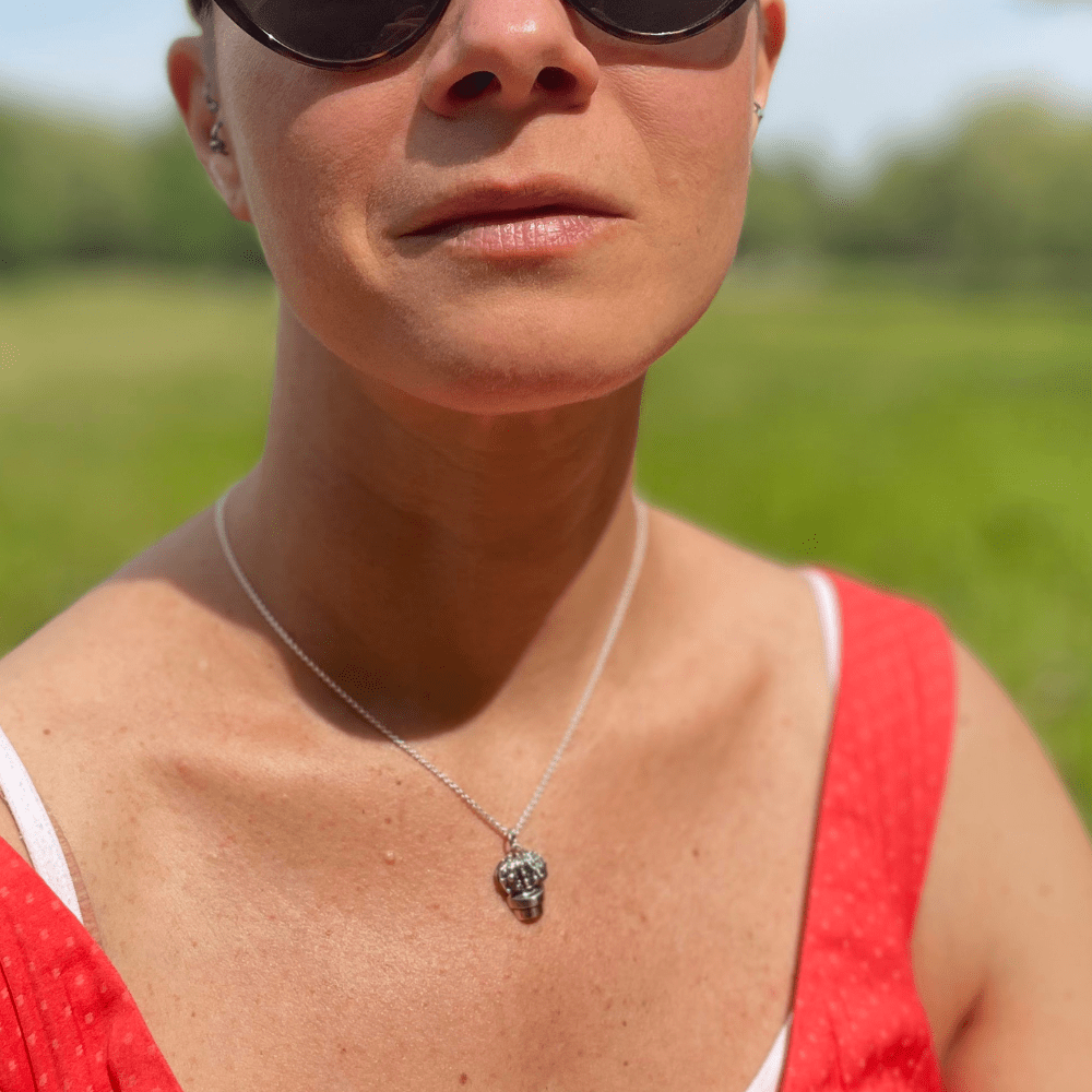 Silver cactus pendant worn on silver chain