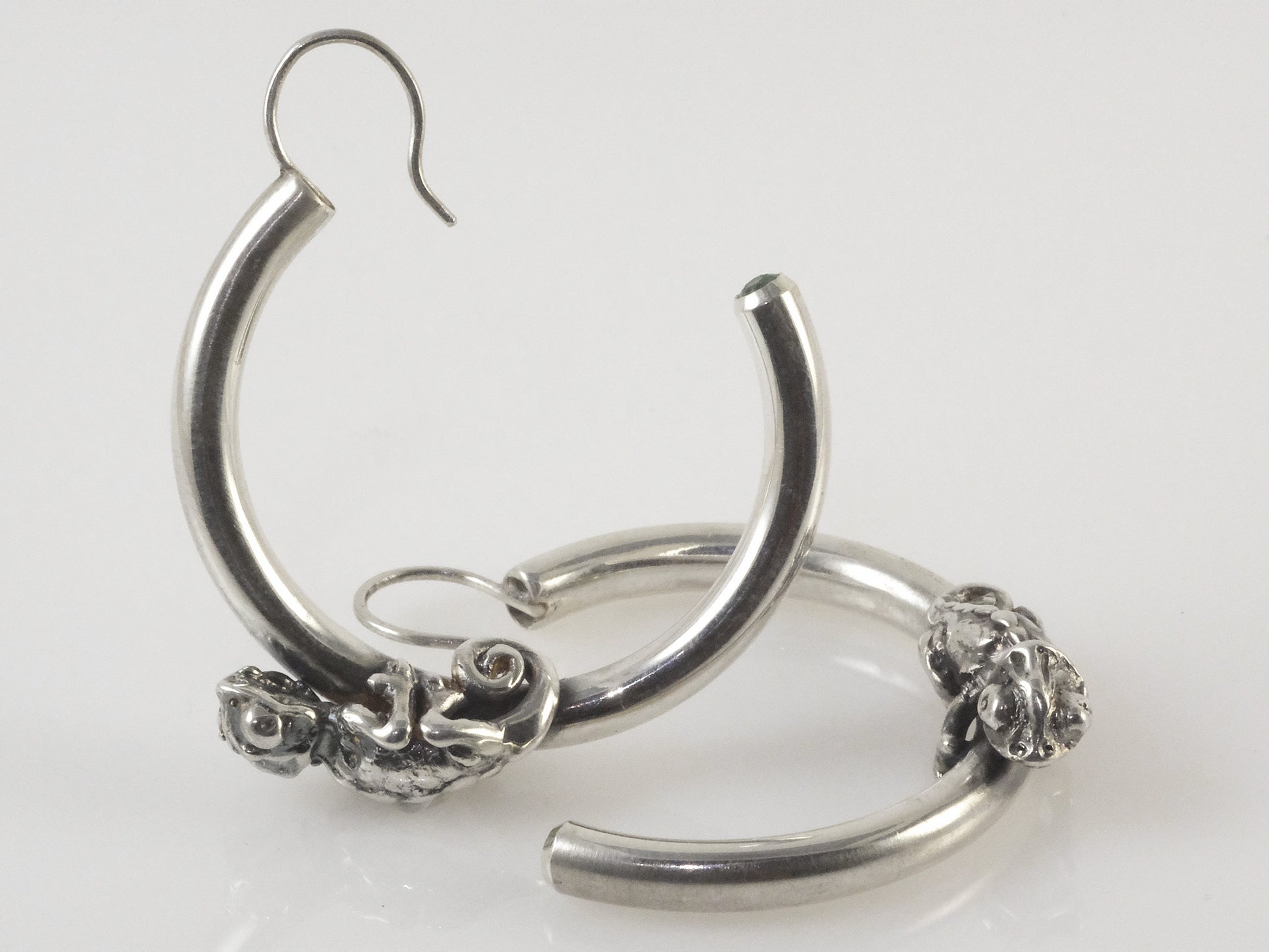 Handmade sterling silver chameleon hoop earrings with tsavorite garnets