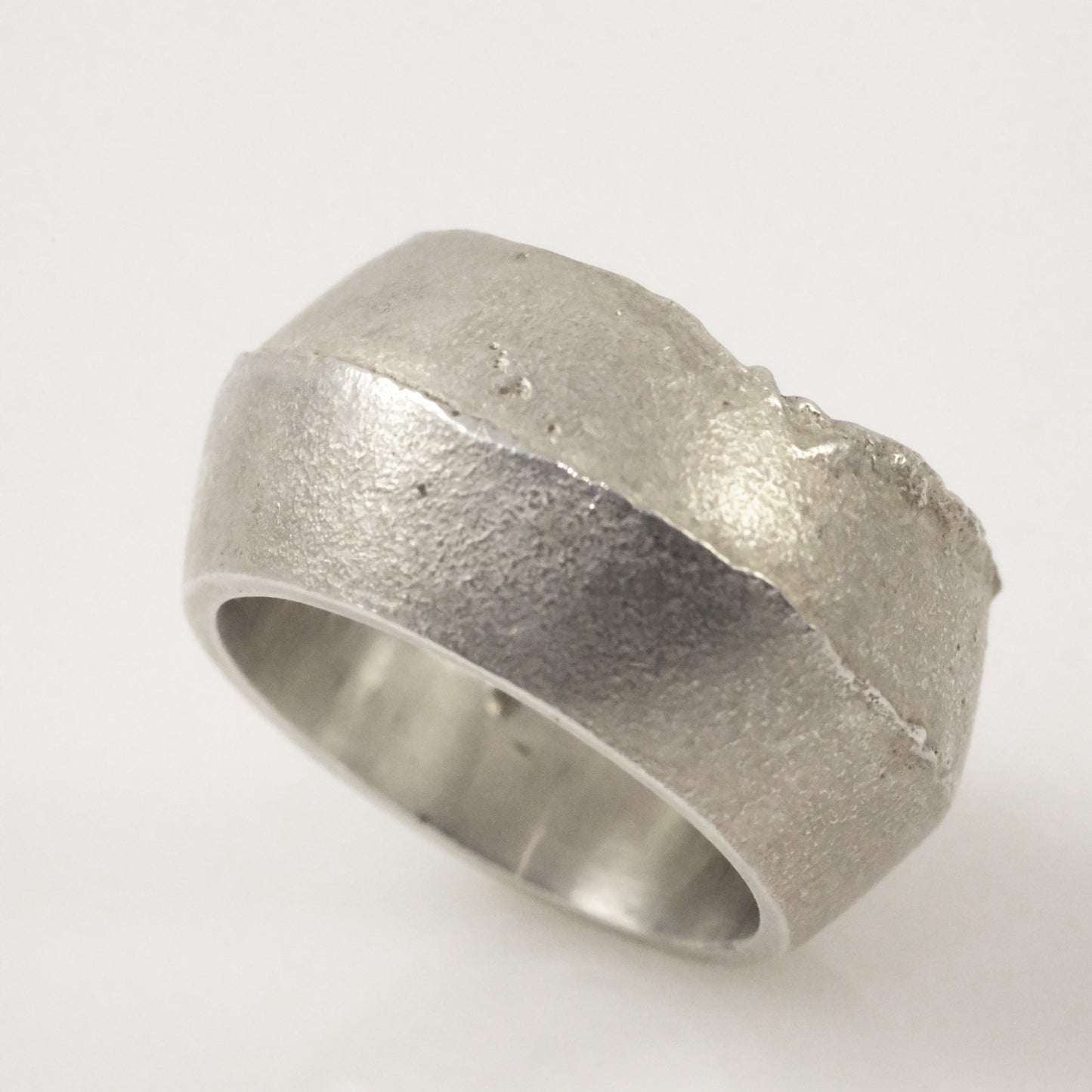 Close-up of sand cast silver ring, unisex jewellery