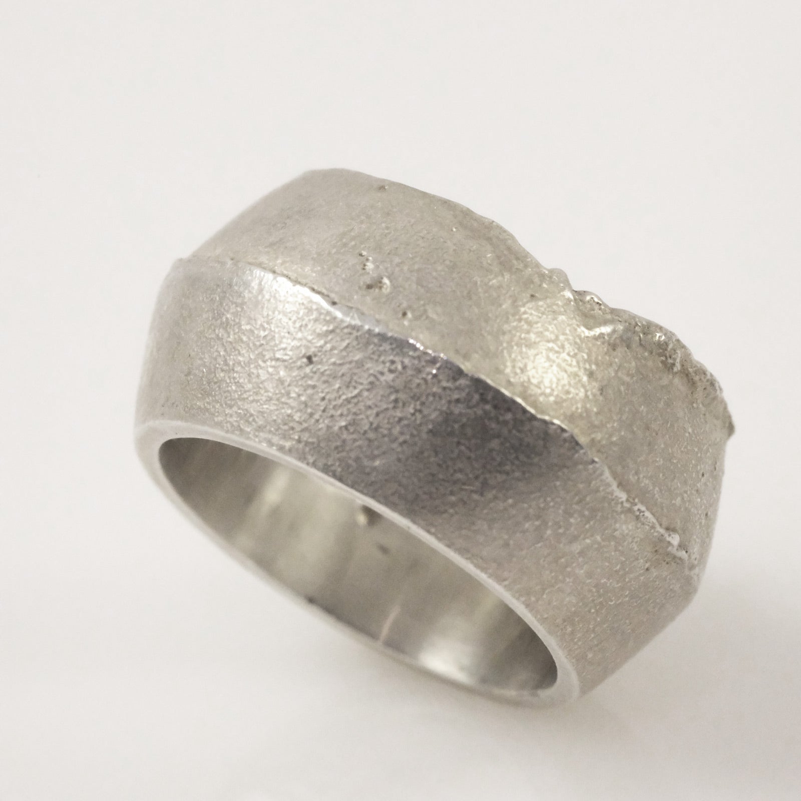 Close-up of sand cast silver ring, unisex jewellery