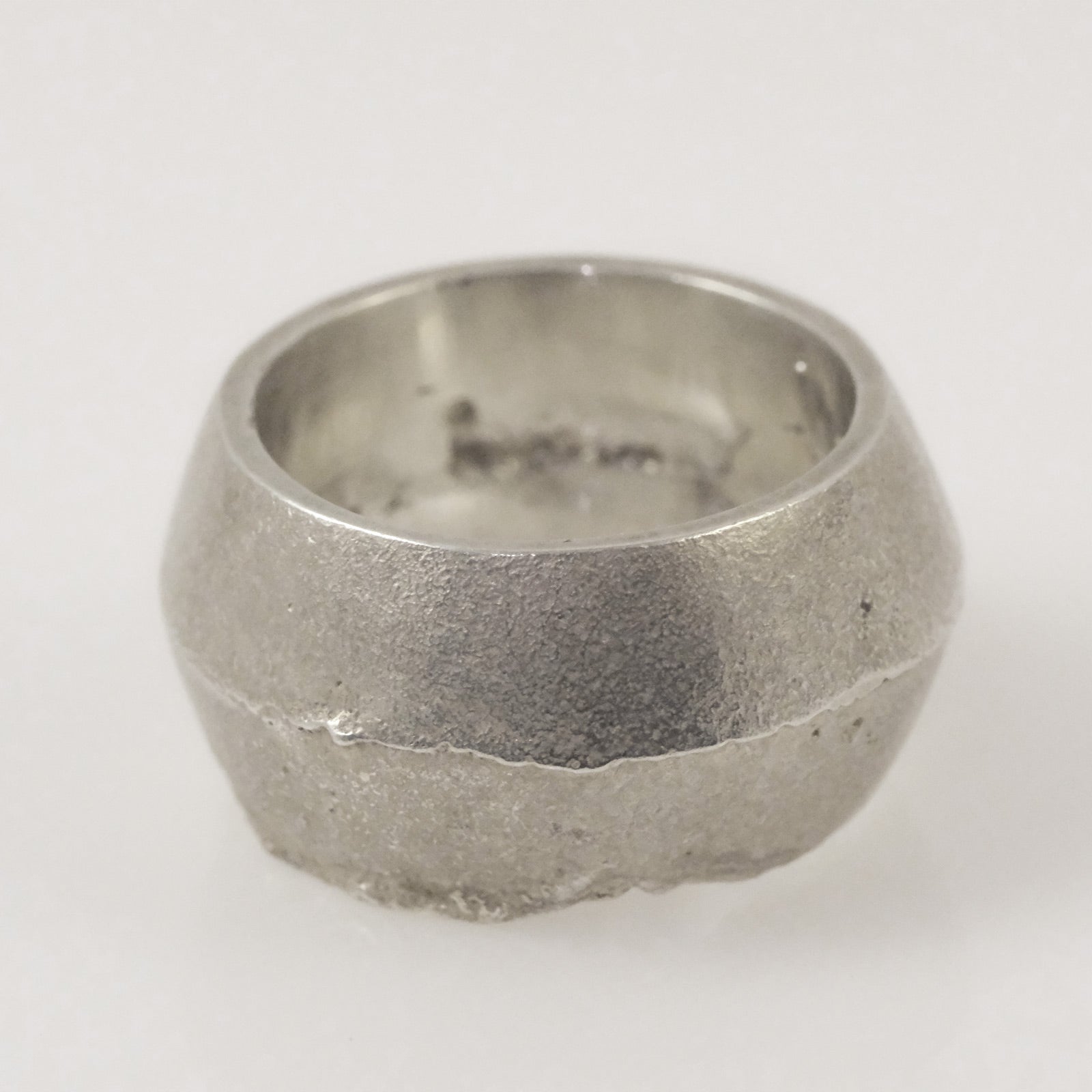 Solid sterling silver ring with sand texture, polished interior