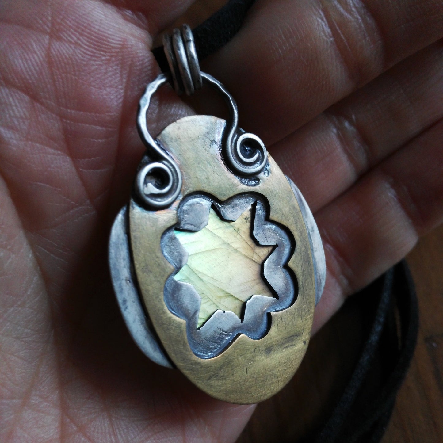 Artisan labradorite pendant with sun and cloud cutouts on the back side