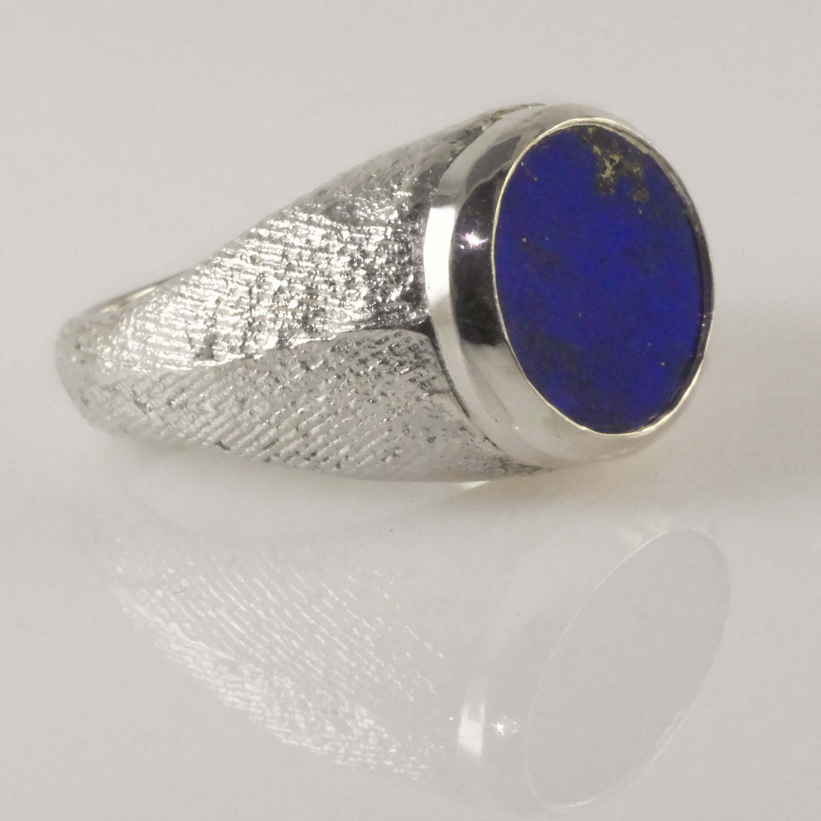 Close-up of artisan silver signet ring with deep blue lapis lazuli slab