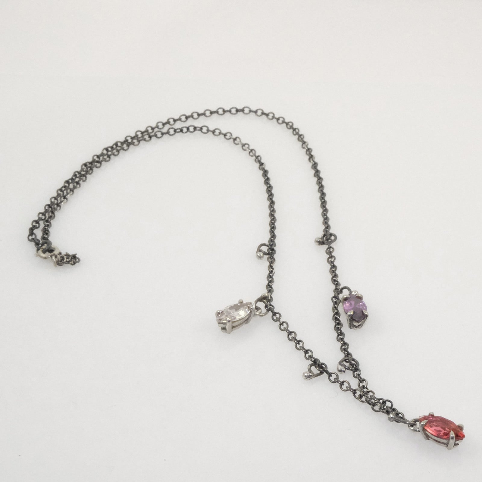 Quirky oxidised silver necklace with three marquise crystals in white, fuchsia, and purple, handmade by VerdeRame Jewels.
