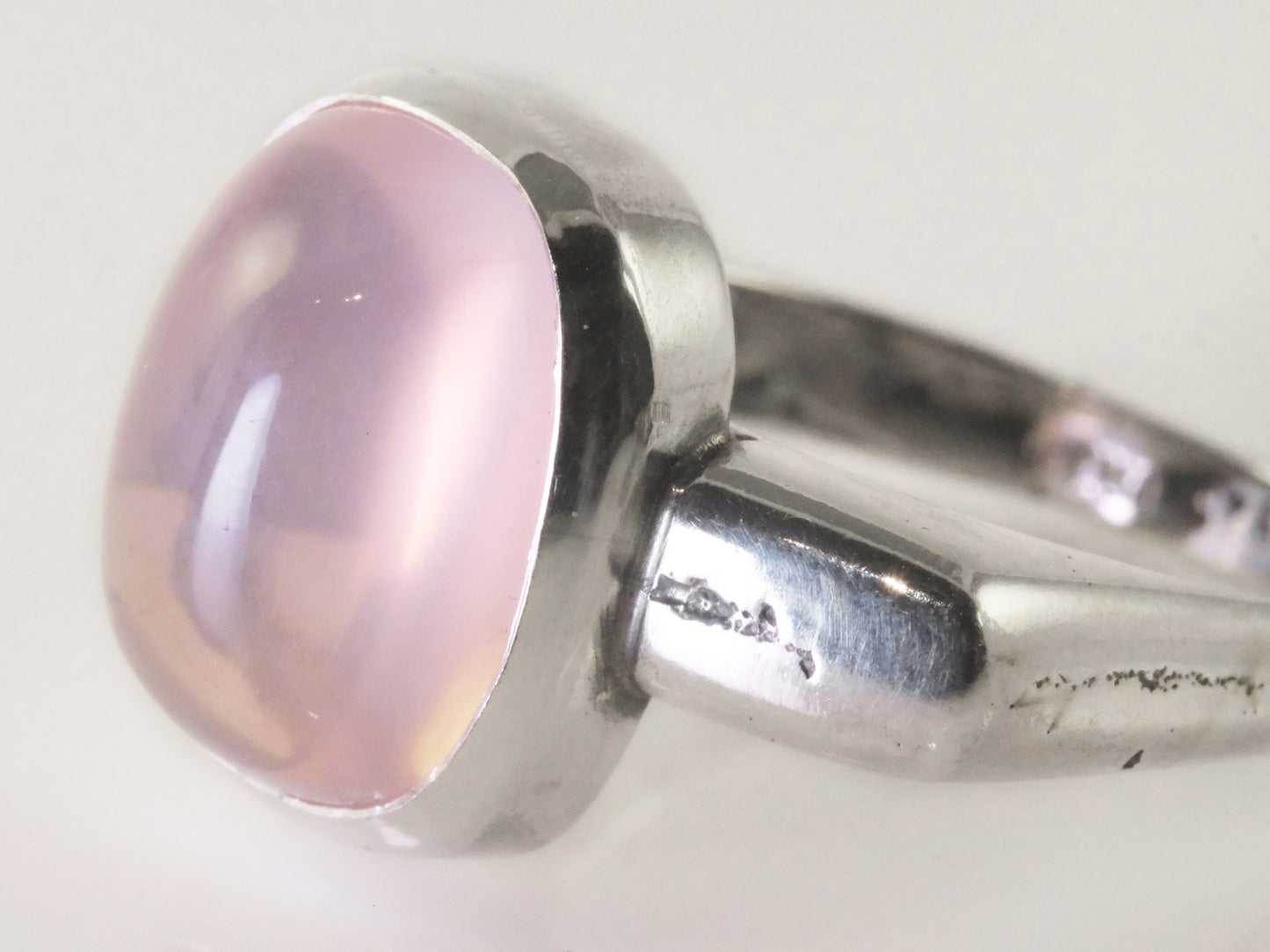 Close-up of pale pink quartz in asymmetric sand-cast silver ring, handmade in Copenhagen