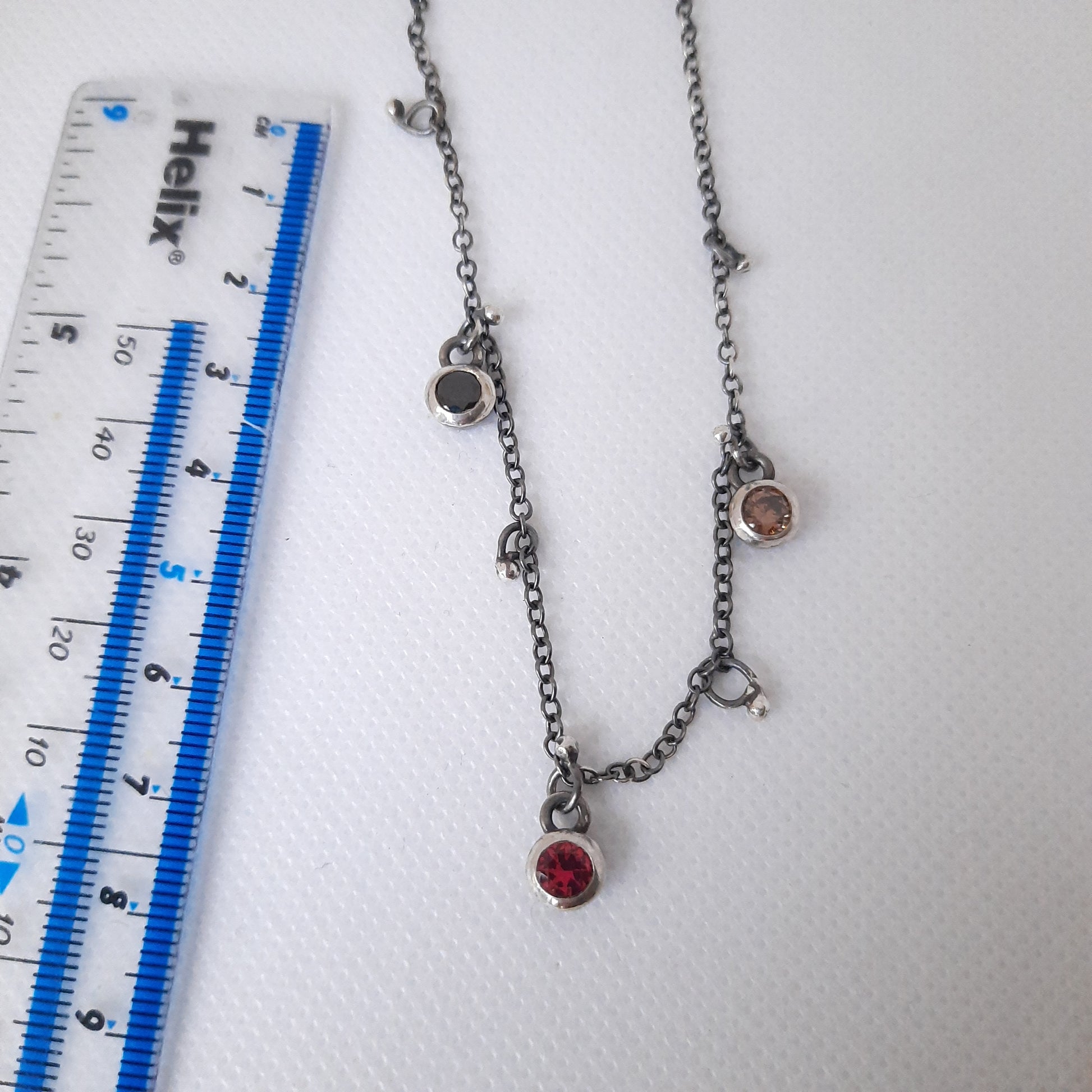 Artisan jewellery with round bezel-set crystals on oxidised silver chain