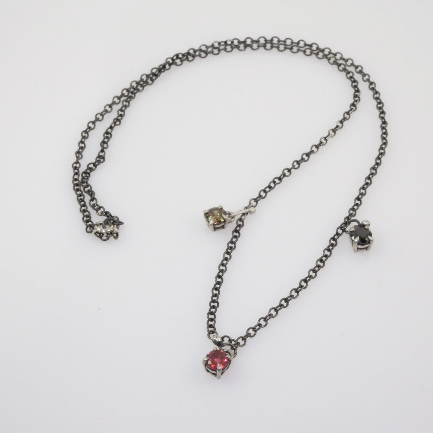 Quirky oxidised silver chain with black, fuchsia, and yellow crystal pendants