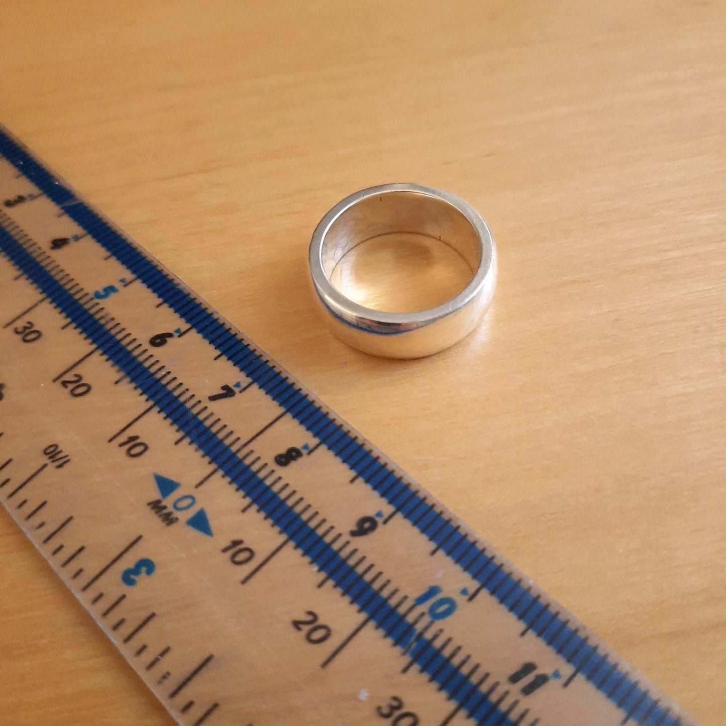 Side view of sterling silver rounded band ring