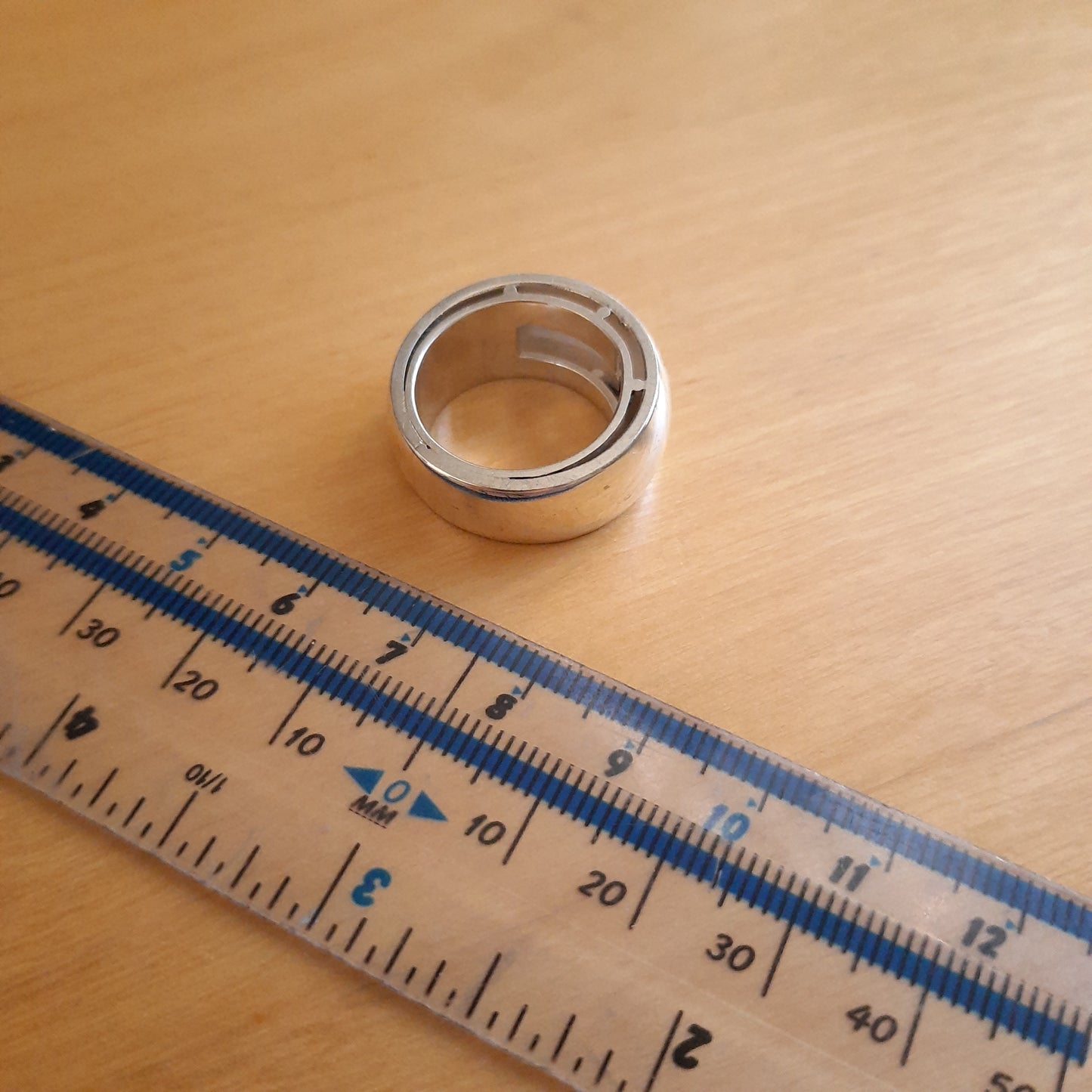 Side view of chunky domed silver ring showing smooth rounded surface.