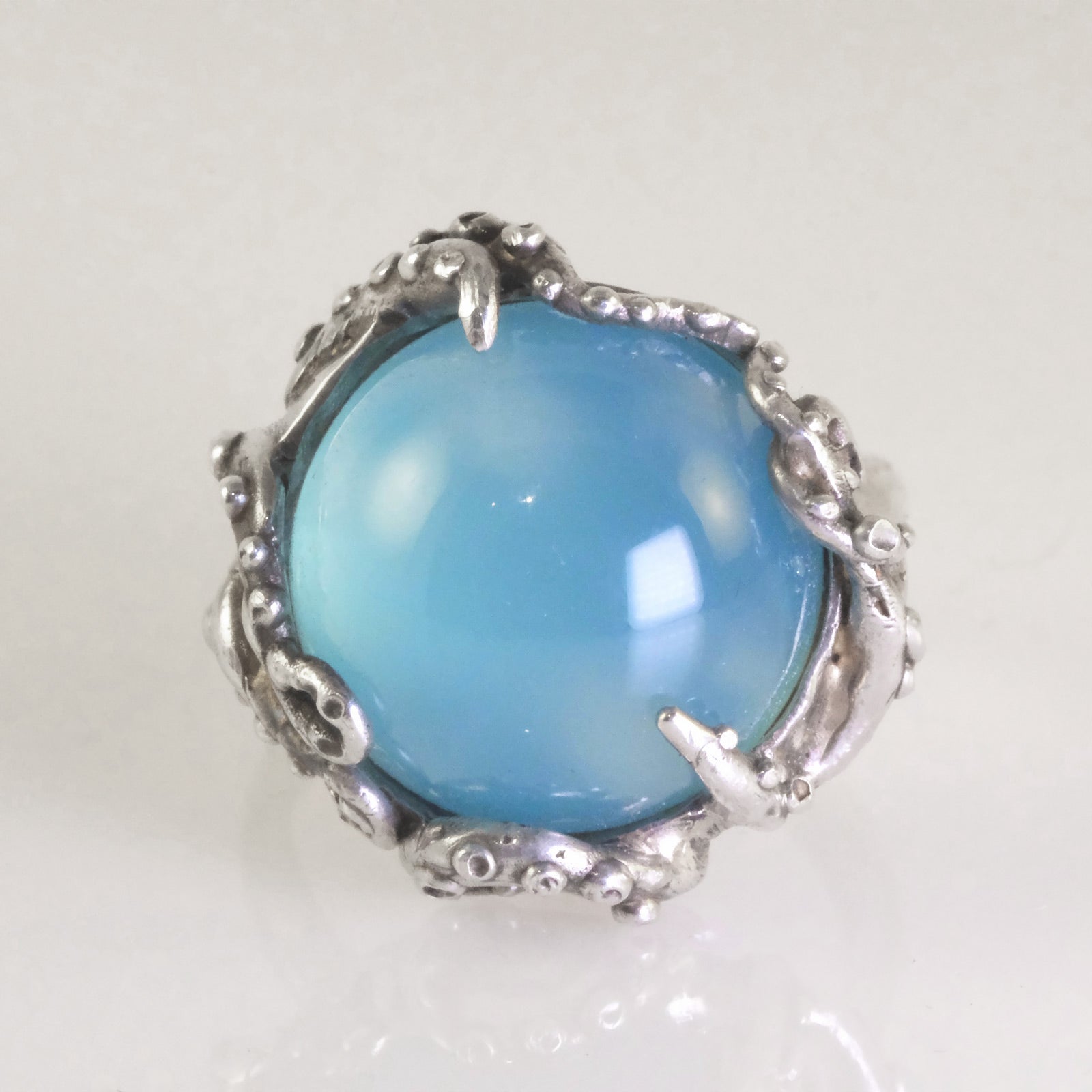Ocean-inspired silver octopus ring with textured tentacles and blue chalcedony