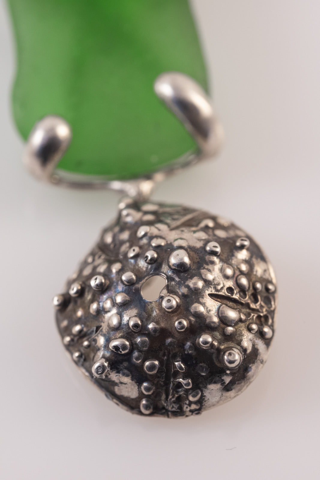 Silver sea urchin and starfish pendant with sea glass detail