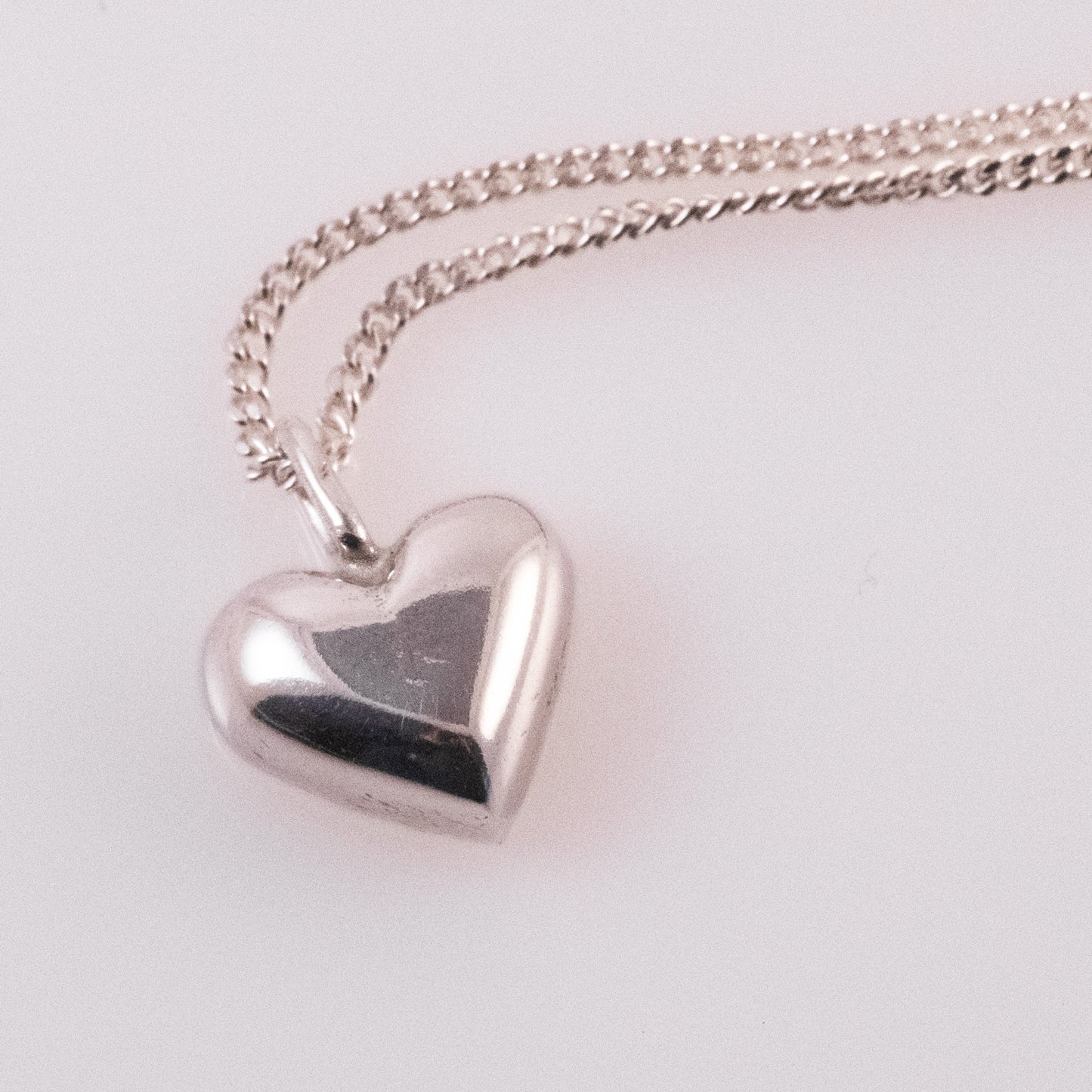 Handmade sterling silver heart pendant with delicate texture