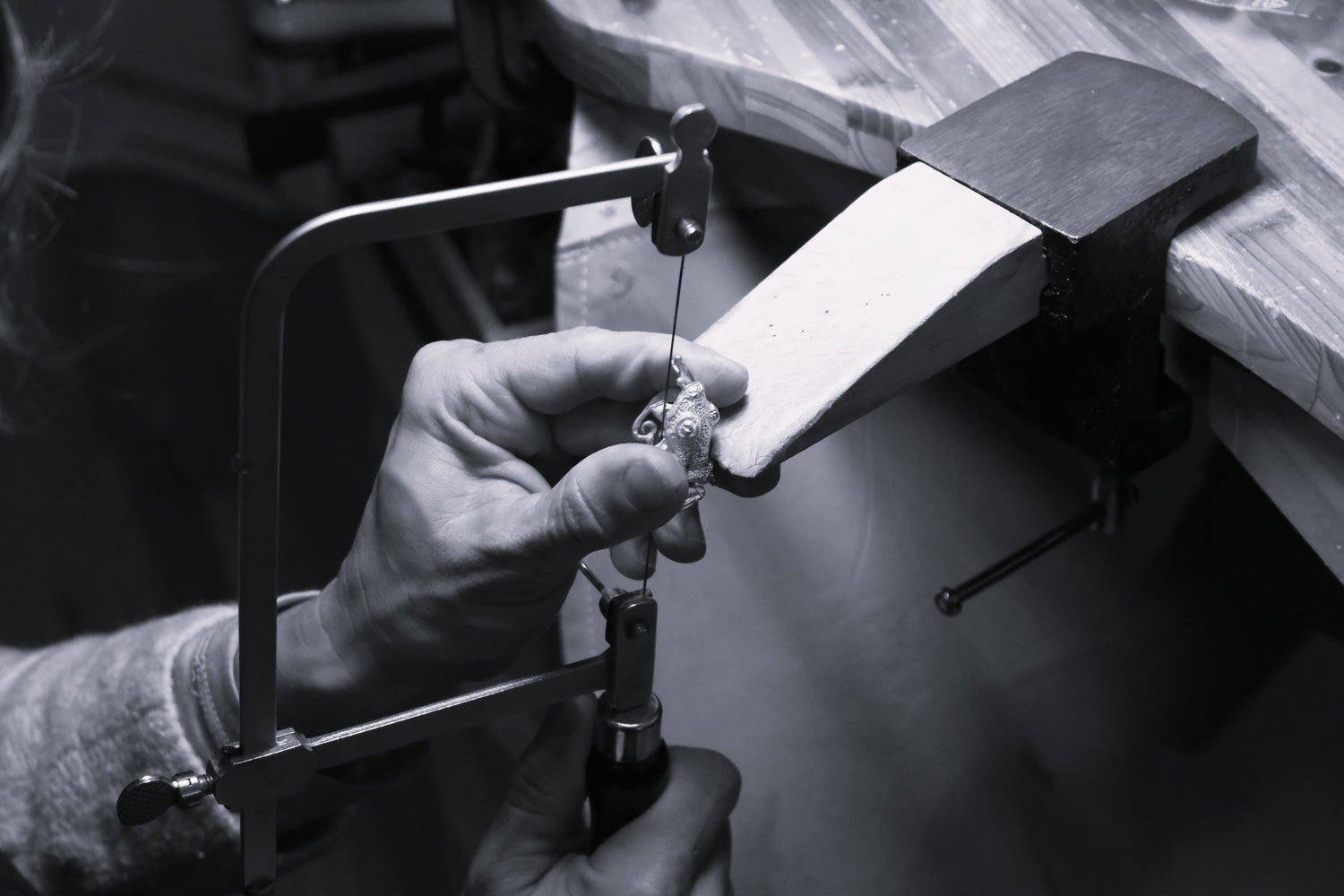 Close-up of artisan sawing handmade sterling silver frog ring at VerdeRame Jewels